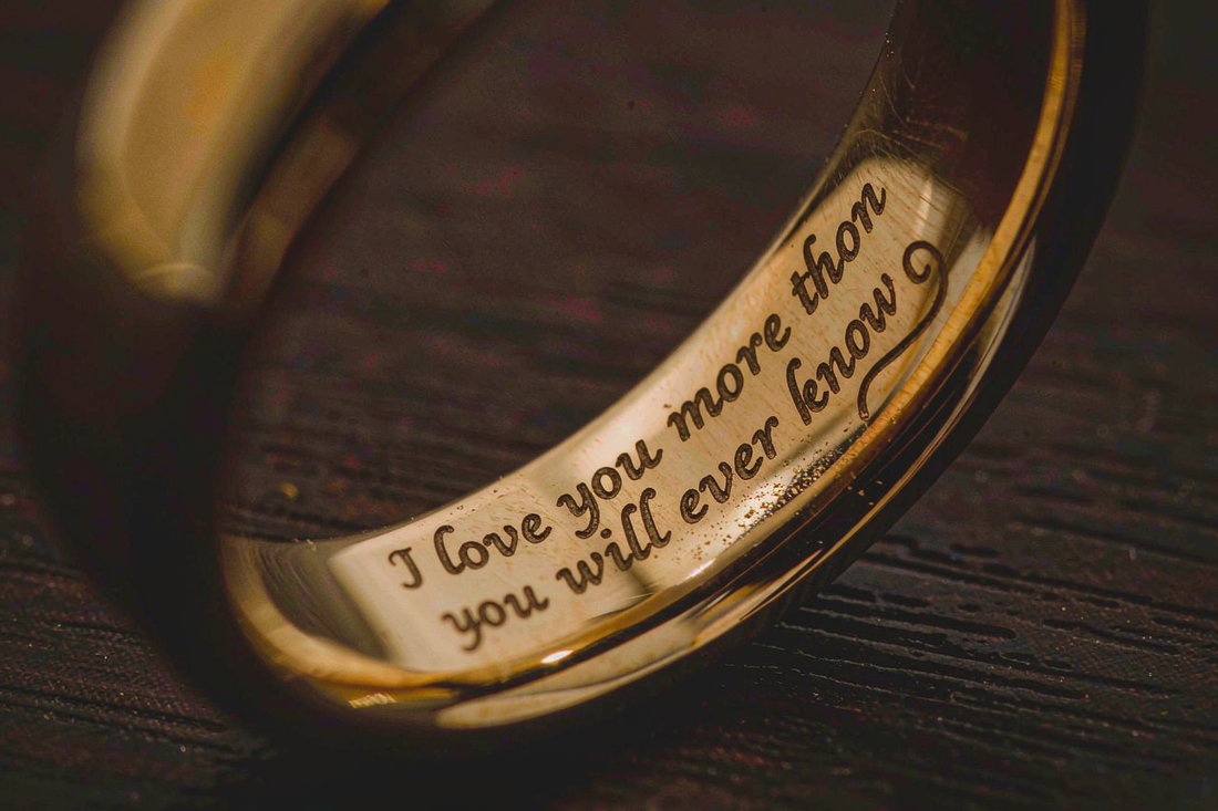 macro close-up of engraved message inside a yellow gold wedding band
