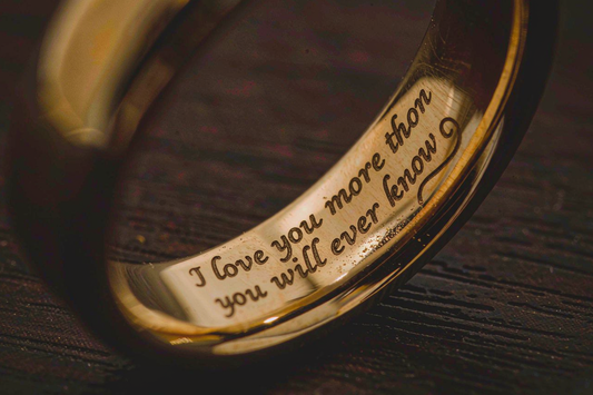 macro close-up of engraved message inside a yellow gold wedding band
