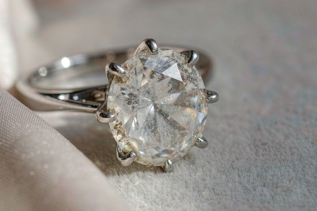 moissanite engagement ring with dull hazy cloudy appearance before cleaning