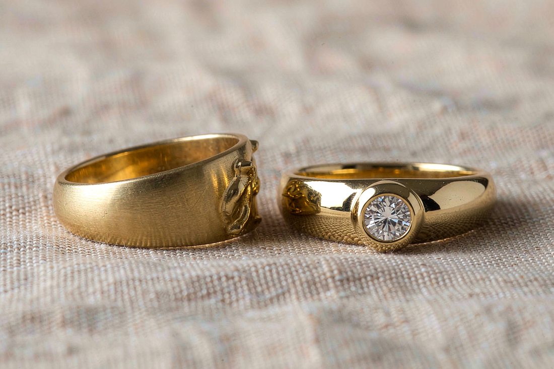 gold vermeil ring and solid 14k gold moissanite ring side by side on cream linen